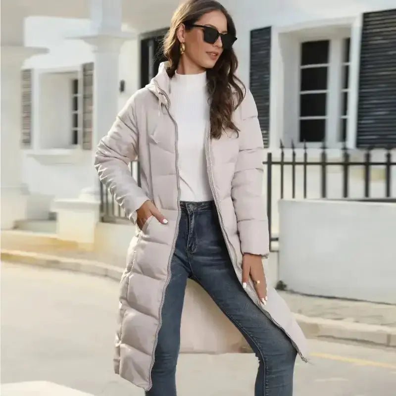 Femme portant une parka femme longue imperméable chaude en extérieur, lunettes de soleil et tenue décontractée.